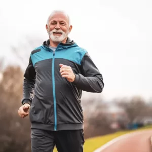 Active senior man is jogging. Healthy retirement lifestyle.